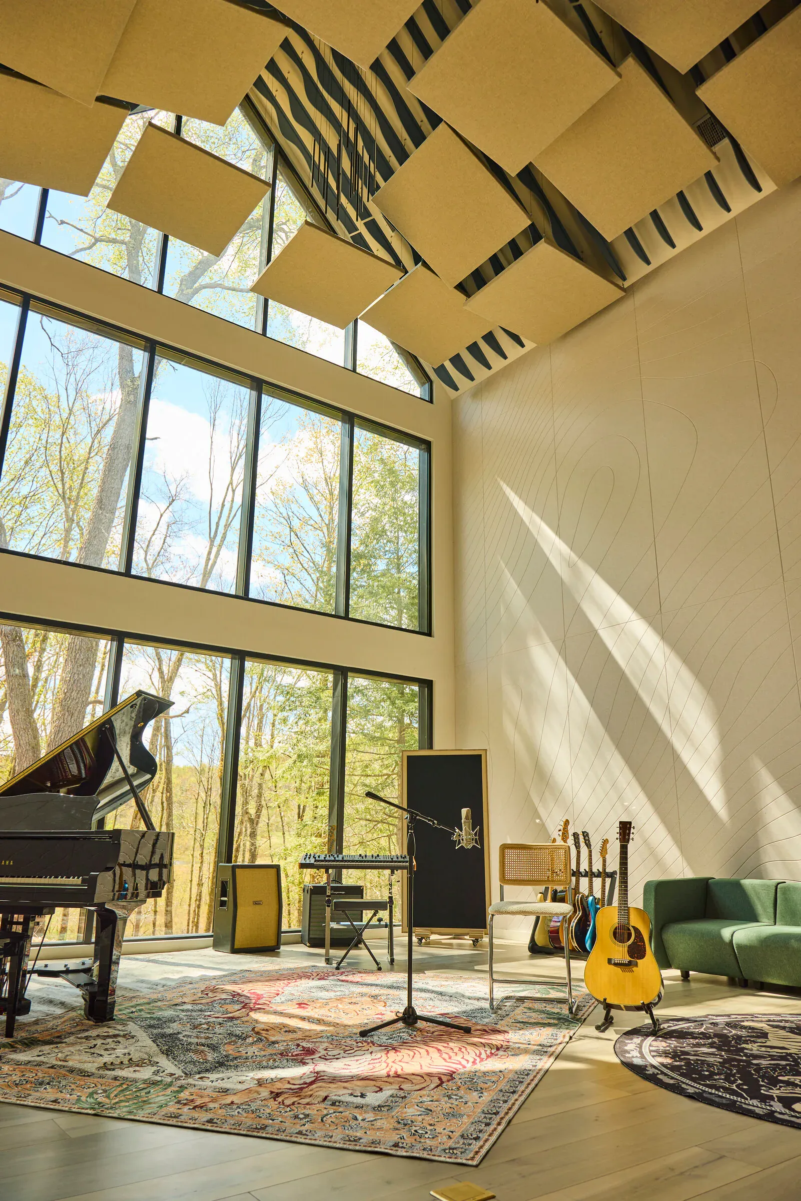 Verdant Sound live room — wide view with 40-foot cathedral ceiling, acoustic panels, and guitars on a tiger rug