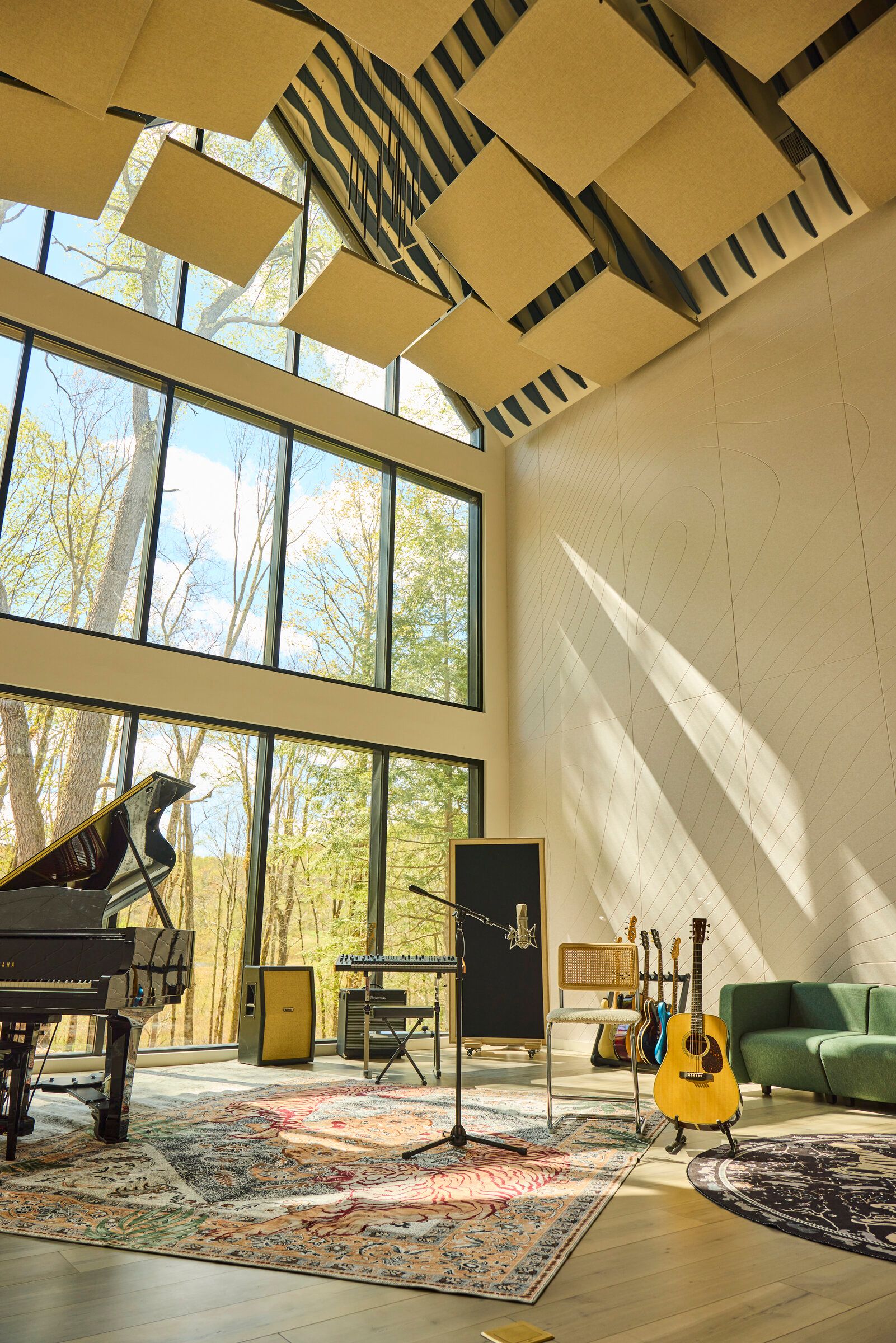 Verdant Sound live room — wide view with 40-foot cathedral ceiling, acoustic panels, and guitars on a tiger rug